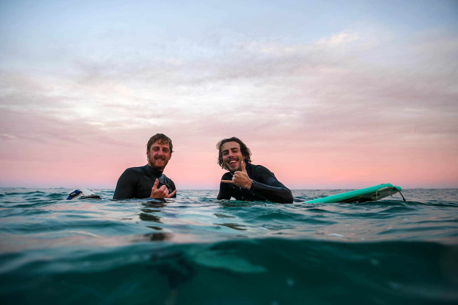 Surfer silhouetted against a sunset